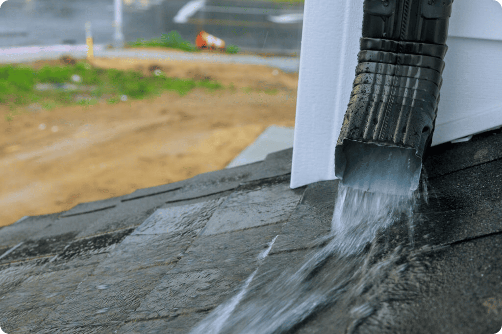 Downspout redirecting rainwater during a gutter protection service by Urban Shield in Bloomington, Indiana