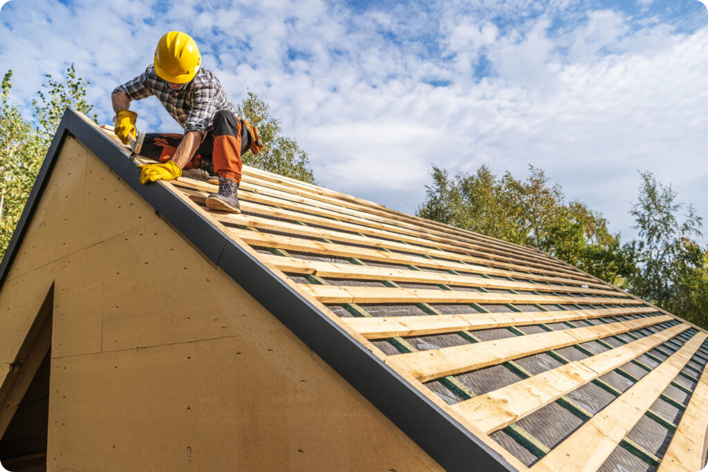 Urban Shield roofing expert installing new shingles on a residential roof in Bloomington, Indiana