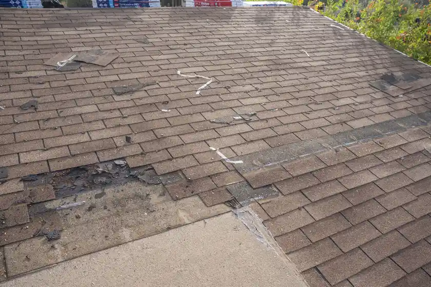 A roof that needs to be replaced due to storm damage, leading to the question "How to negotiate roof replacement with insurance"